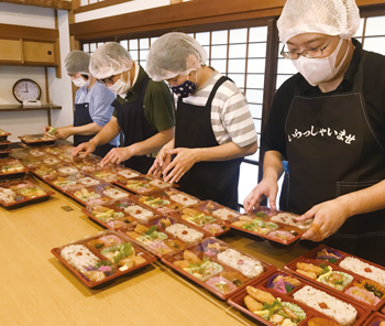 配達用弁当の盛り付け作業